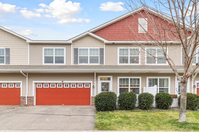 view of front facade with driveway, a front yard, and a garage
