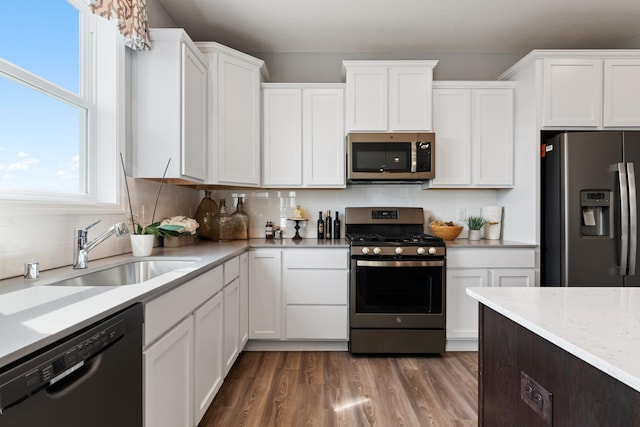 1064 Aster Blvd, Rosemount, MN 55068 - kitchen featuring stainless steel appliances, a sink, white cabinets, and backsplash