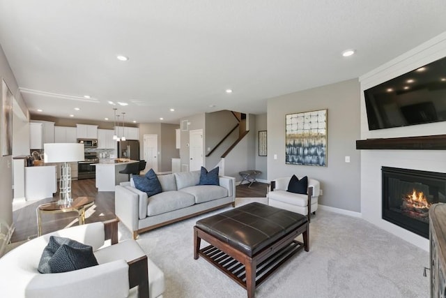 1064 Aster Blvd, Rosemount, MN 55068 - living area with recessed lighting, a fireplace, baseboards, light carpet, and stairway