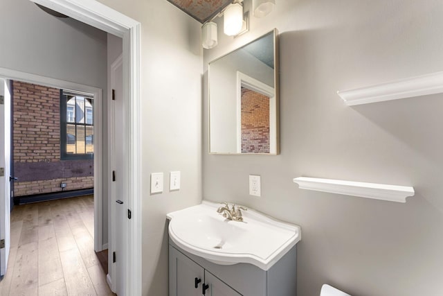 bathroom with vanity and wood finished floors