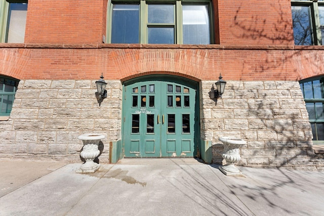doorway to property with stone siding