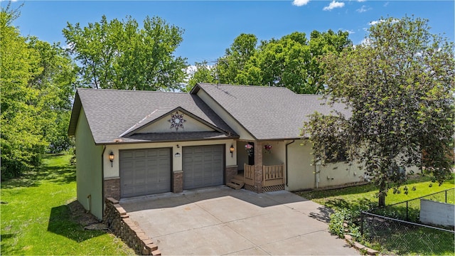 344 Barker St, Hastings, MN 55033 - view of front of home with an attached garage, concrete driveway, brick siding, a shingled roof, and stucco siding