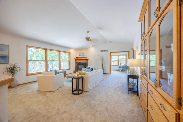 344 Barker St, Hastings, MN 55033 - living room with a ceiling fan, lofted ceiling, light carpet, and a glass covered fireplace