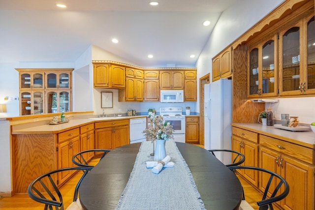 344 Barker St, Hastings, MN 55033 - kitchen featuring white appliances, a peninsula, glass insert cabinets, light countertops, and recessed lighting