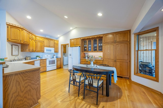344 Barker St, Hastings, MN 55033 - kitchen with white appliances, vaulted ceiling, light wood-style flooring, glass insert cabinets, and light countertops