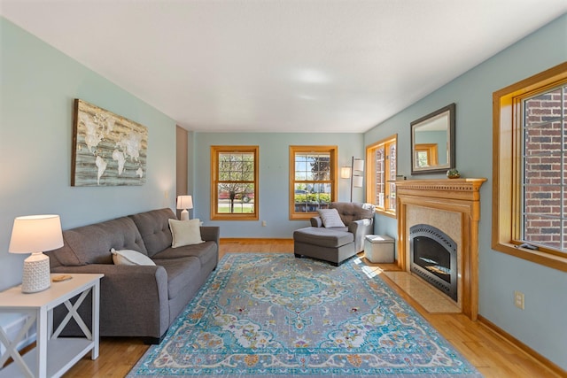 2606 Hulett Ct, Faribault, MN 55021 - living area with light wood-style flooring, a fireplace with flush hearth, and baseboards