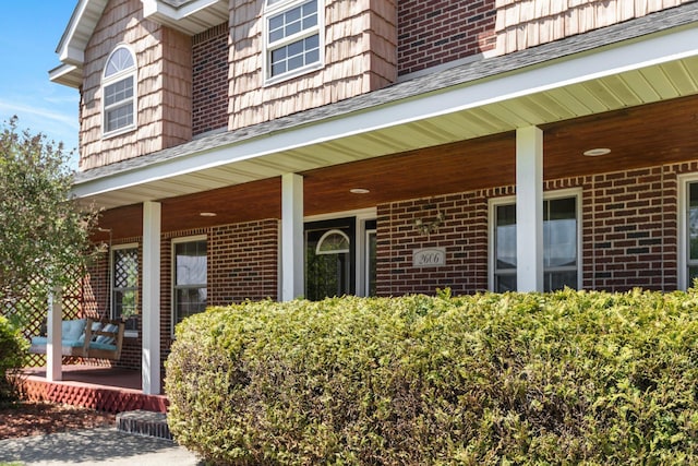 2606 Hulett Ct, Faribault, MN 55021 - property entrance with a porch and brick siding
