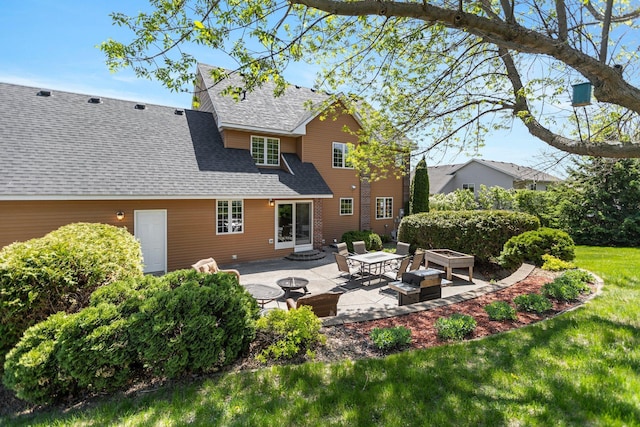 2606 Hulett Ct, Faribault, MN 55021 - rear view of property featuring a patio, a shingled roof, an outdoor fire pit, and a lawn