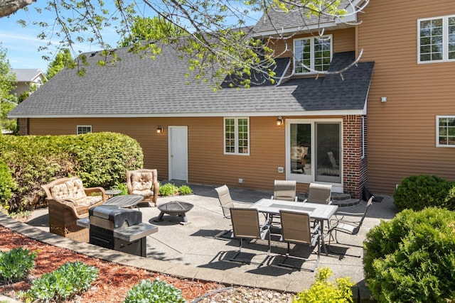 2606 Hulett Ct, Faribault, MN 55021 - back of house featuring an outdoor living space with a fire pit, a shingled roof, and a patio area