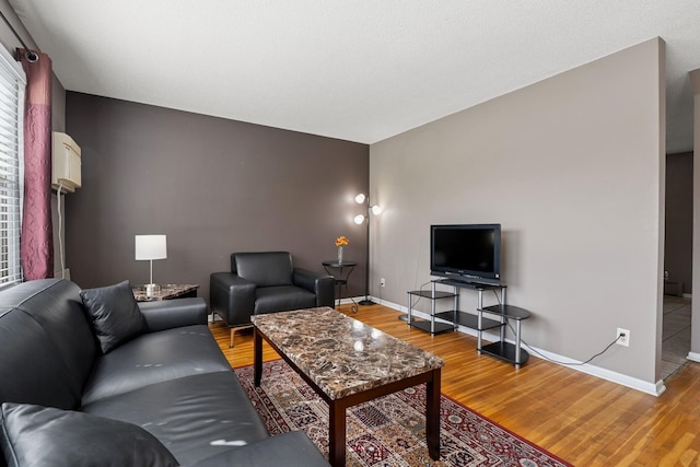 living room featuring baseboards and light wood-type flooring
