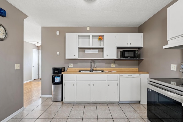 kitchen featuring white dishwasher, black microwave, a sink, stainless steel electric stove, and under cabinet range hood