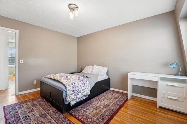 bedroom featuring baseboards and light wood-style flooring