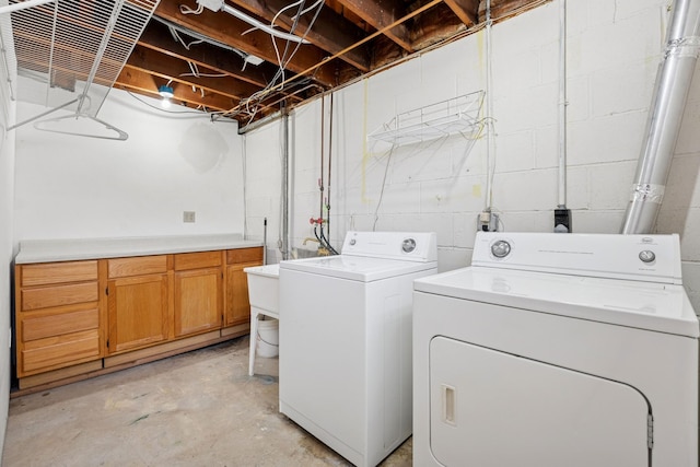 laundry area with cabinet space and independent washer and dryer