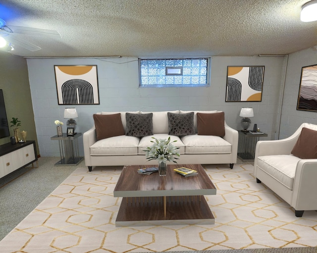 living room featuring light colored carpet, a ceiling fan, a textured ceiling, and concrete block wall