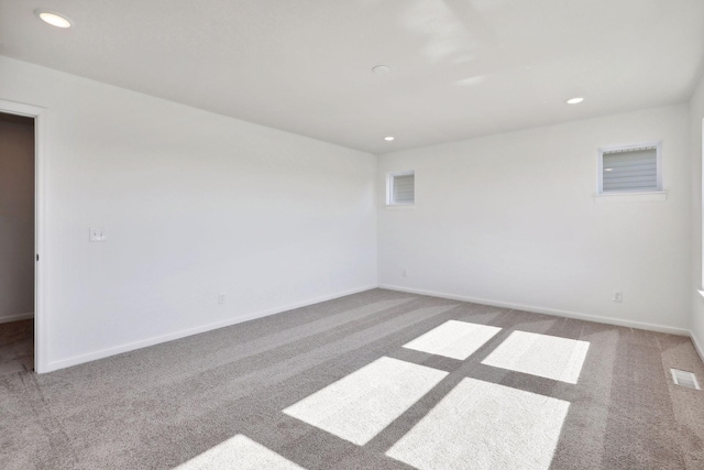 spare room with carpet flooring, recessed lighting, and baseboards