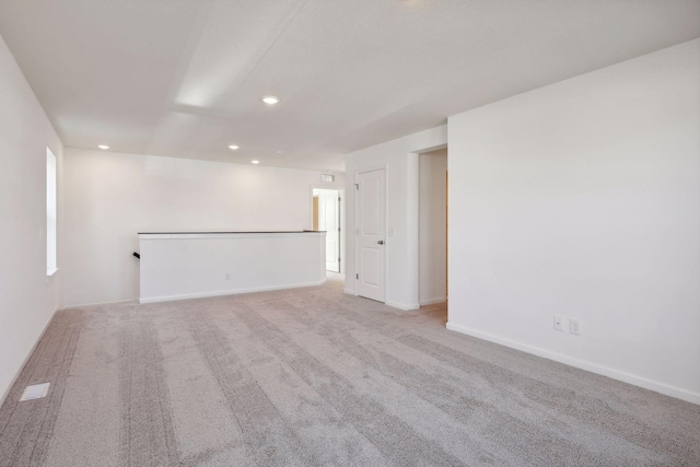 unfurnished room with recessed lighting, carpet, and baseboards