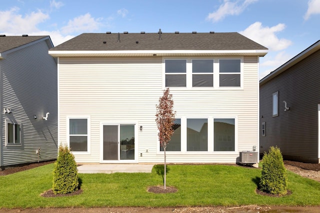 back of property featuring a lawn, central air condition unit, and a patio