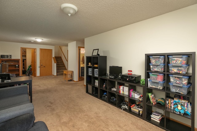 carpeted living area featuring stairs and a textured ceiling