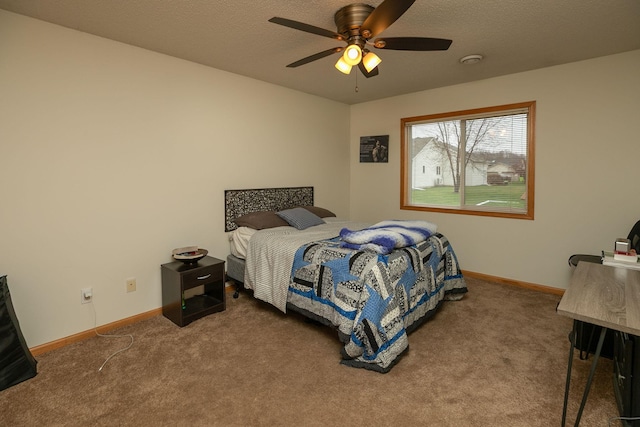 carpeted bedroom with a ceiling fan and baseboards