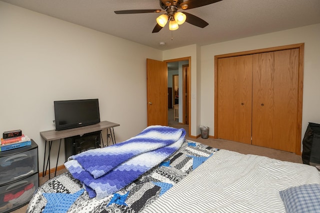 carpeted bedroom featuring baseboards, ceiling fan, and a closet