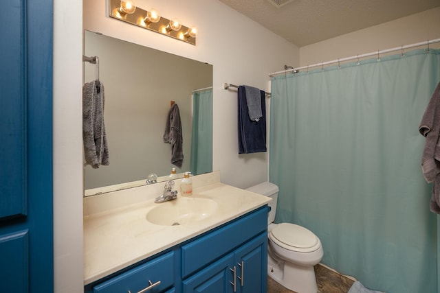 full bath featuring vanity, toilet, and a textured ceiling