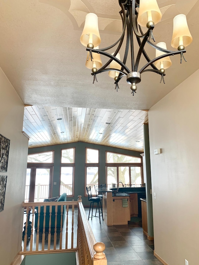 79317 355th St, Clinton, MN 56225 - hall featuring lofted ceiling, a chandelier, and baseboards