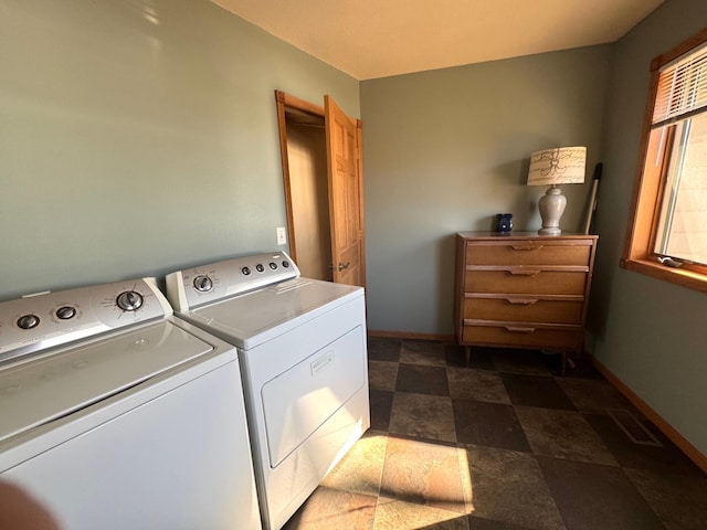 79317 355th St, Clinton, MN 56225 - laundry area with washer and clothes dryer, stone finish flooring, and baseboards