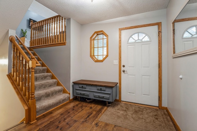 2686 56th Ave, Princeton, MN 55371 - entrance foyer featuring wood finished floors, stairs, a textured ceiling, and baseboards