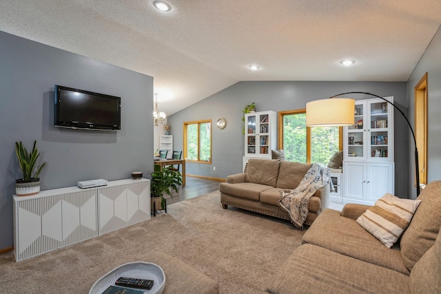 2686 56th Ave, Princeton, MN 55371 - carpeted living room featuring vaulted ceiling, baseboards, a textured ceiling, and wood finished floors