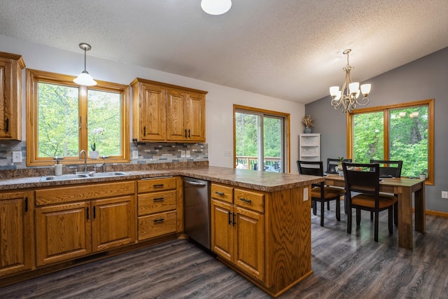 2686 56th Ave, Princeton, MN 55371 - kitchen featuring a sink, brown cabinetry, lofted ceiling, a textured ceiling, and a peninsula
