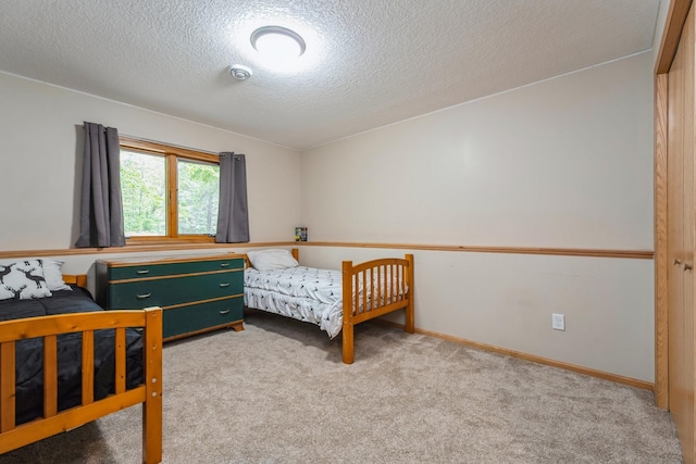 2686 56th Ave, Princeton, MN 55371 - bedroom featuring carpet floors, a textured ceiling, and baseboards