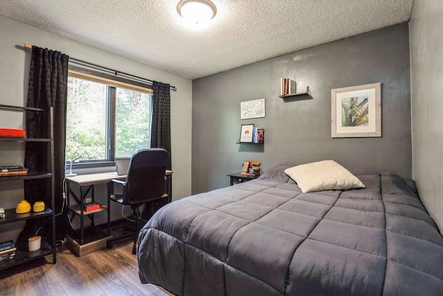 2686 56th Ave, Princeton, MN 55371 - bedroom featuring wood finished floors, a textured ceiling, and an office area
