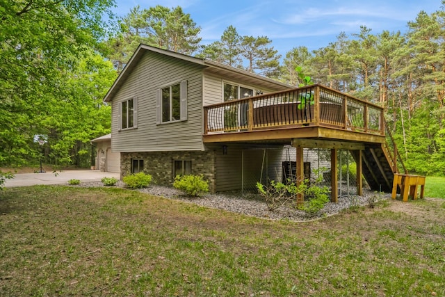 2686 56th Ave, Princeton, MN 55371 - back of property with a wooden deck, a garage, stairs, and a lawn