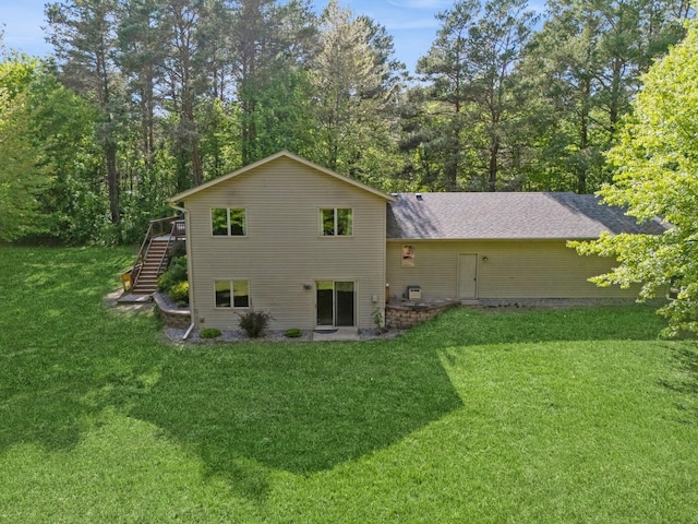 2686 56th Ave, Princeton, MN 55371 - back of house featuring stairway, a lawn, and a deck