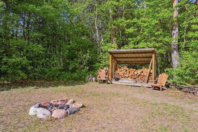 2686 56th Ave, Princeton, MN 55371 - view of yard with a fire pit and a forest view