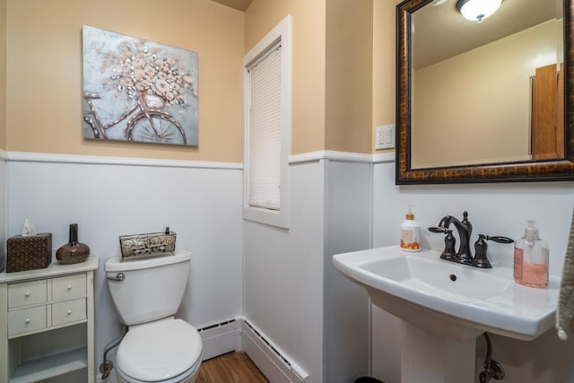 118 Golf Ter, Crookston, MN 56716 - half bath featuring toilet, a baseboard heating unit, and a sink