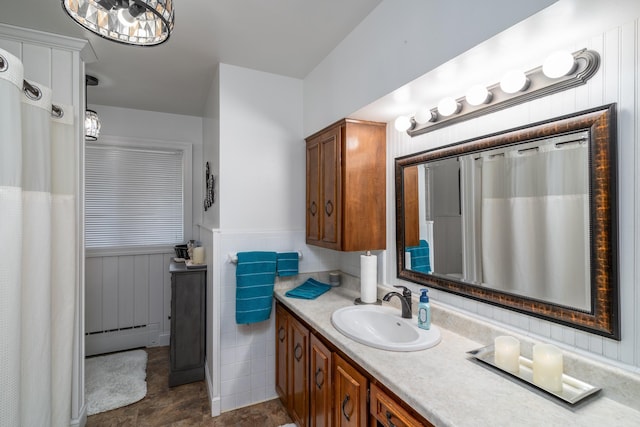 118 Golf Ter, Crookston, MN 56716 - bathroom featuring vanity, tile patterned flooring, a baseboard heating unit, and a wainscoted wall