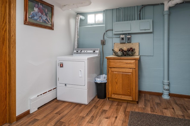 118 Golf Ter, Crookston, MN 56716 - clothes washing area featuring cabinet space, a baseboard heating unit, washer / dryer, and wood finished floors