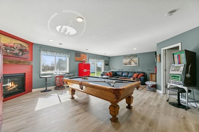 23892 187th St NW, Big Lake, MN 55309 - rec room with billiards table, wood finished floors, a large fireplace, baseboards, and recessed lighting