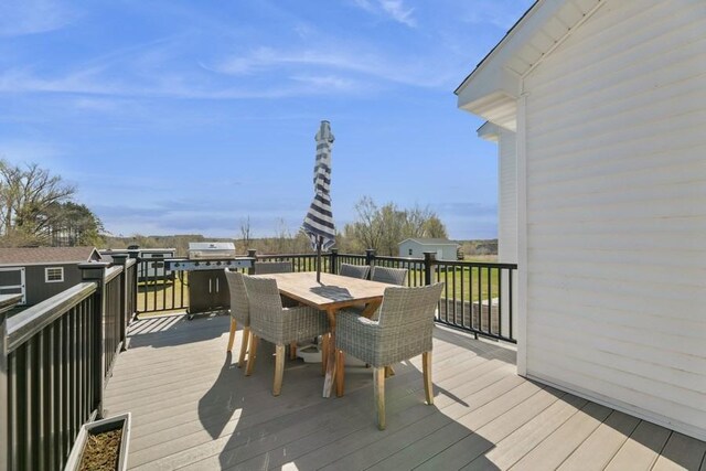 23892 187th St NW, Big Lake, MN 55309 - wooden terrace with outdoor dining space and grilling area