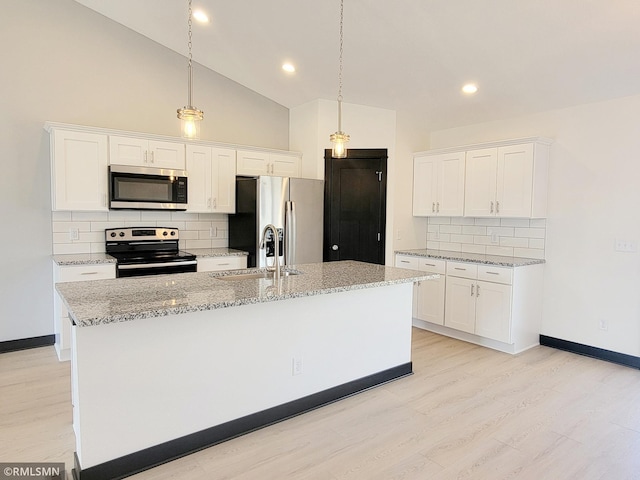 kitchen featuring a sink, appliances with stainless steel finishes, tasteful backsplash, and white cabinetry