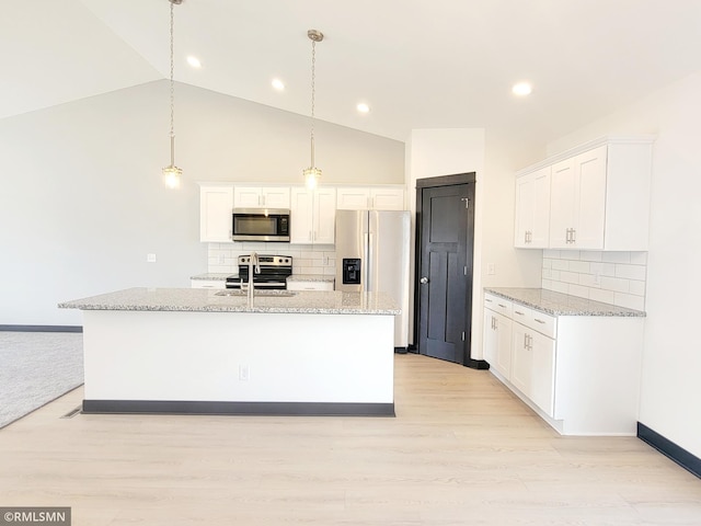 kitchen with backsplash, white cabinets, and appliances with stainless steel finishes