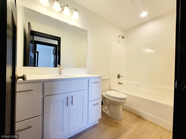 full bathroom with vanity, shower / bathtub combination, toilet, recessed lighting, and wood finished floors