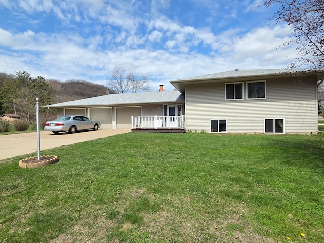 313 Saehler Dr, Goodview, MN 55959 - view of front of home with concrete driveway, an attached garage, and a front yard