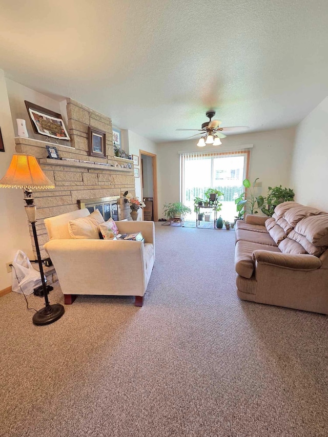 313 Saehler Dr, Goodview, MN 55959 - carpeted living room with a textured ceiling, a fireplace, and ceiling fan