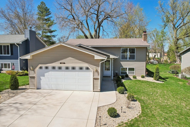 raised ranch with an attached garage, driveway, a chimney, and a front yard