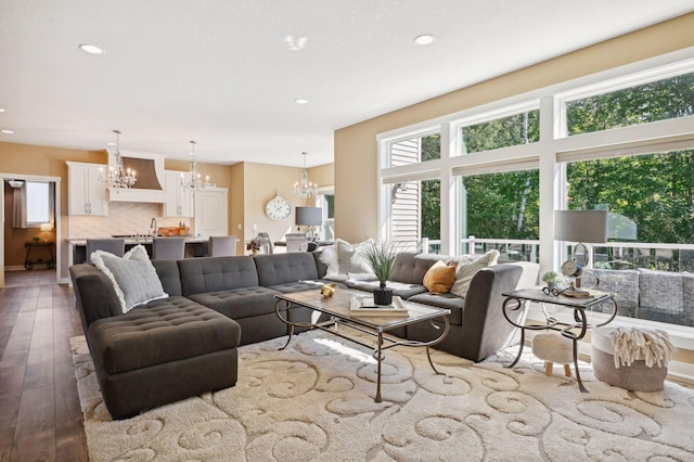 living area featuring wood-type flooring, recessed lighting, and a chandelier