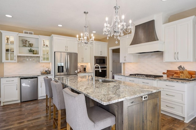 kitchen with visible vents, an inviting chandelier, custom range hood, a sink, and appliances with stainless steel finishes