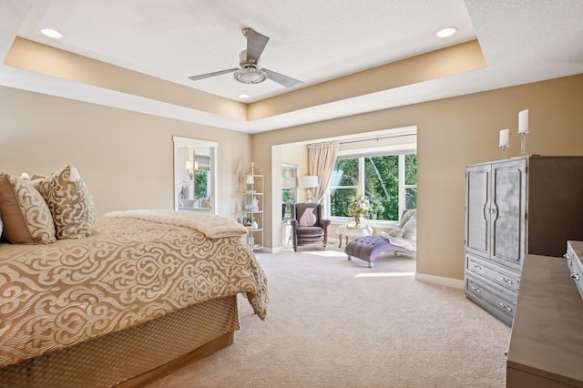 carpeted bedroom with baseboards, a ceiling fan, a raised ceiling, and recessed lighting