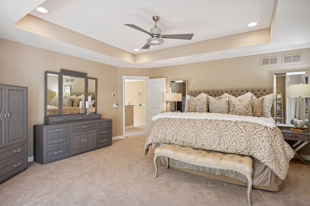 bedroom featuring visible vents, recessed lighting, a raised ceiling, and light carpet